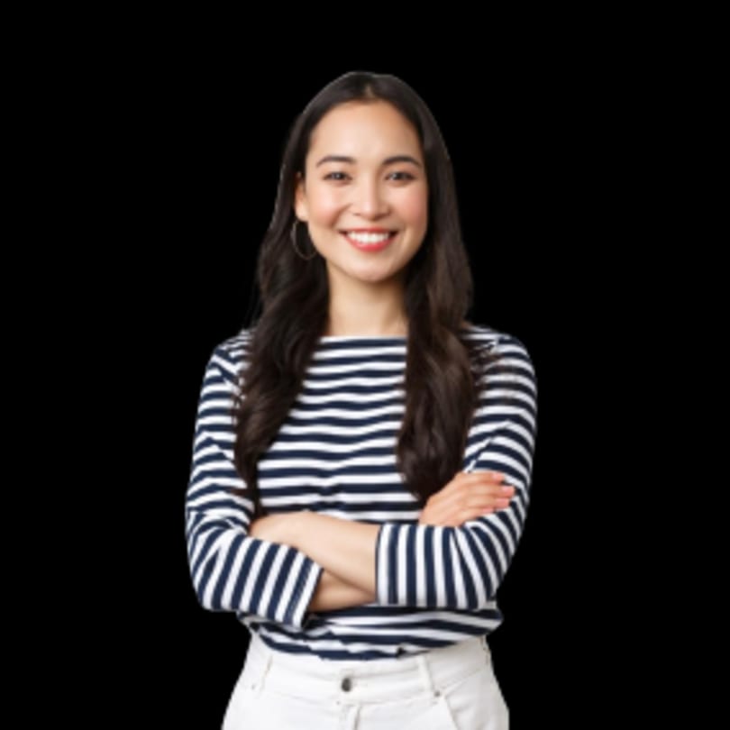 Smiling woman with long dark hair, wearing a striped shirt and white pants, arms crossed.